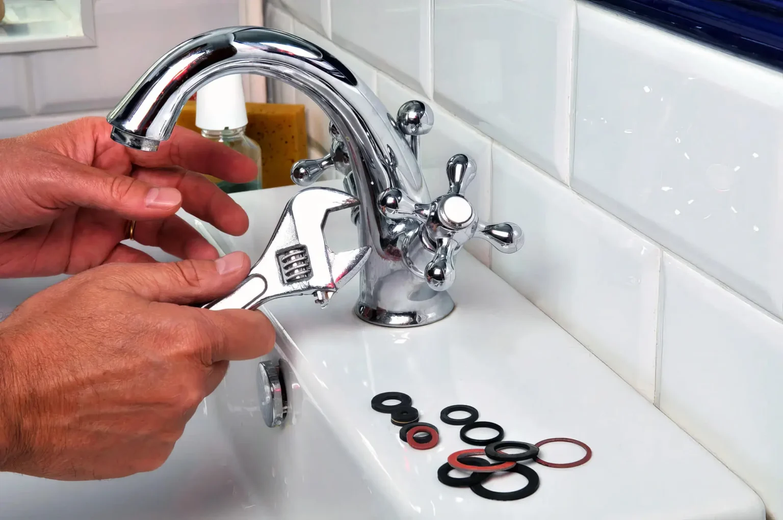 Plumber maintaining a bathroom faucet in Reedley