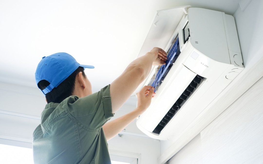 HVAC technician servicing a ductless mini split in Reedley