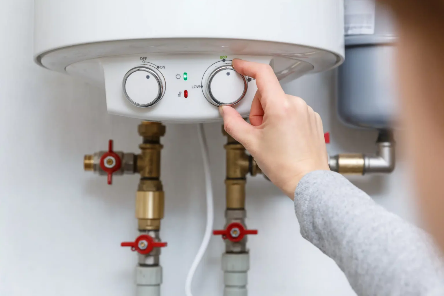 Technician adjusting a water heater in Reedley